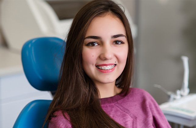 Woman in orthodontic chair with braces